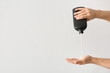 © Pixel-Shot - Male hands with bottle of shampoo on light background