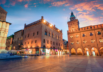 Great spring sunset of the main square of City of Bologna with Palazzo d'Accursio and facade of Basilica di San Petronio. Great cityscape of Bologna, Italy, Europe.