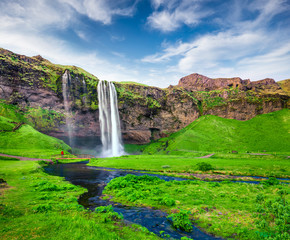  Beautiful morning view of Seljalandfoss Waterfall on Seljalandsa river in summer. Colorful summer scene of Iceland, Europe. Beauty of nature concept background.
