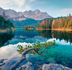 Splendid morning scene of Eibsee lake with Zugspitze mountain range on background. Colorful autumn view of Bavarian Alps, Germany, Europe. Beauty of nature concept background.