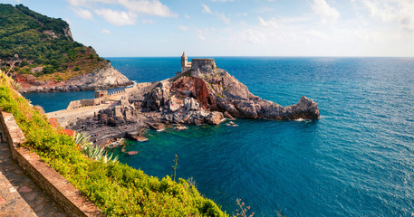 Sunny morning view of Saint Peter Church in Portovenere town. Picturesque spring seascape of Mediterranean sea,  Liguria, province of La Spezia, Italy, Europe. Traveling concept background.