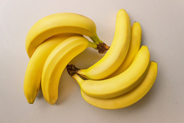 Bunch of ripe bananas on a light background. Concept- organic fruit, healthy food.