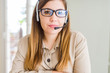 © Krakenimages.com - Beautiful young operator woman wearing headset at the office Relaxed with serious expression on face. Simple and natural with crossed arms