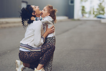 Cheerful mother and daughter having fun in city