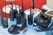 © Kirill Gorlov - Many portable radio transceivers on table at technology exhibition. Different walkie-talkie radio set. Communication devices choice for military and civil use