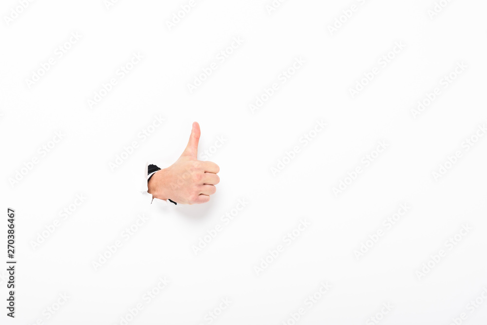 man showing thumb up from hole in paper wall on white with copy space - obrazy, fototapety, plakaty 