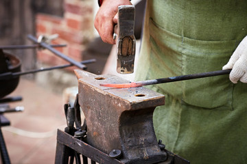 Blacksmith with a hammer in his hands working