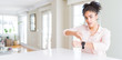 © Krakenimages.com - Wide angle of beautiful african american woman with afro hair In hurry pointing to watch time, impatience, upset and angry for deadline delay