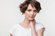 © Drobot Dean - Portrait of young woman with short brown hair in basic t-shirt looking at camera