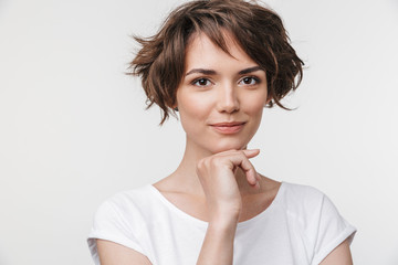 Canvas Print - Portrait of cute woman with short brown hair in basic t-shirt looking at camera