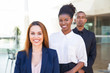 © Mangostar - Happy business people posing indoors. Man and woman in formal clothes standing for camera in office space and smiling. Business portrait and successful businesspeople concept