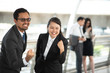 © ic36006 - Portrait Of Cheerful Business Colleagues Clenching Fists In Office