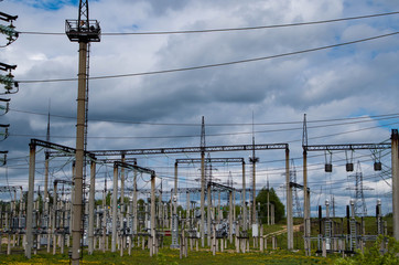 Electricity distribution station. Lots of wires, poles and shields.