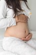 © Djordje - girl holding her pregnant stomach. five month of pregnancy