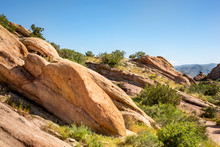 Red Rocky Terrain And Dry Brush At Vasquez Rocks Natural Area Park In Agua Dulce