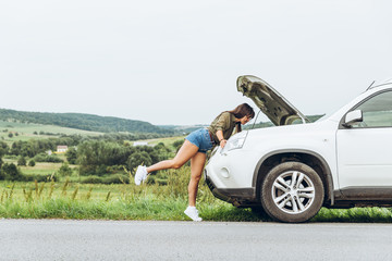 woman in tight shirts new broken car with opened hood