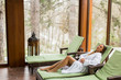 © BGStock72 - Young woman relaxing on the deckchair by the swimming pool in spa