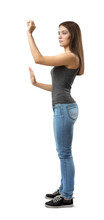Side View Of Young Woman In Top And Jeans Standing, One Arm With Open Palm At Belly Level, Other Before Face In Pinch Gesture Isolated On White Background.