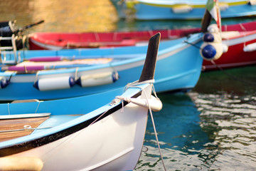 Colourful fishing boats in small marina of Vernazza, one of the five centuries-old villages of Cinque Terre, located on rugged northwest coast of Italian Riviera.