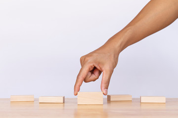 Wall Mural - Hand choose empty wooden blocks on white background. Concept of decision making and choices success in the future goal