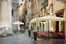 Beautifully Decorated Small Outdoor Restaurant Tables In The City Of Lucca, Italy