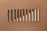 Fototapeta Sypialnia - Row of burnt matches and whole one on color background, flat lay. Human life phases concept