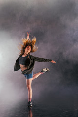 Wall Mural - Female dancer shows off her elegance by moving her back leg high over her head.