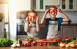 © JenkoAtaman - Healthy eating. Happy children prepares  vegetable salad in kitchen
