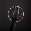 © ink drop - Male open hand gesture on a dark background with abstract neon light glow