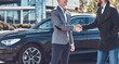 © Fxquadro - Photo of two smart elegant men, which have a deal about car. They are doing handshake.