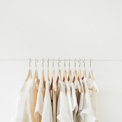 Wall Mural - Feminine clothes on hanger. Minimal fashion composition on white background.