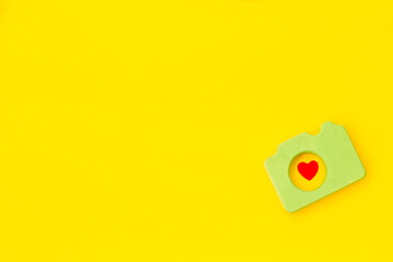 Blogger concept with photo camera on yellow background top view mockup