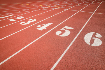 Red running track, track and field or athletics track start line with lane numbers