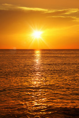 Poster - Colorful empty seascape with shiny sea over cloudy sky and sun during sunset in Cozumel, Mexico