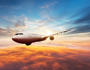 Wall Mural - passengers commercial airplane flying above clouds