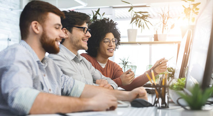 Group of young programmers developing data code