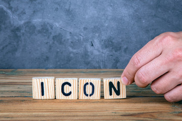 Wall Mural - icon - word from wooden letters on wooden table