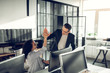 Businessman giving high five to his helpful smart assistant