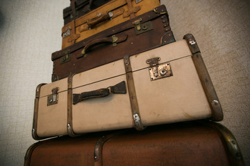 Old hand suitcases on a shelf in a junk shop