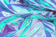 Abstract trendy holographic background. Real texture in pale violet and mint colors with scratches and irregularities