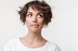 © Drobot Dean - Portrait closeup of elegant woman with short brown hair in basic t-shirt smiling and looking aside