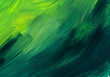 Macro texture of painted surface. Brush marks on the paint. Chaotic strokes of gradient grassy, green, emerald color.