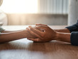 © StratfordProductions - Friends holding each other's hand on desk