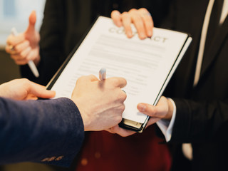 Partmership and cooperation. Business deal. Corporate relationship. Closeup of man hand signing contract.