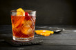 © Andrey - Whiskey sour cocktail with a slice of orange, cherry and ice, a classic alcoholic drink on black background