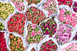 © Bisual Studio/Stocksy - Overhead view of variety of rose flowers in sacks at market