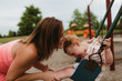 © Alicia Magnuson Photography/Stocksy - Red-Headed Toddler Playing on Playground with His Mother in Summertime