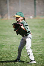 Young Female Baseball Player Ready To Catch A Ball