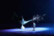 Concept Picture Of A Businessman Looking At Aladdin Lamp With Smoke, Asking For A Wish