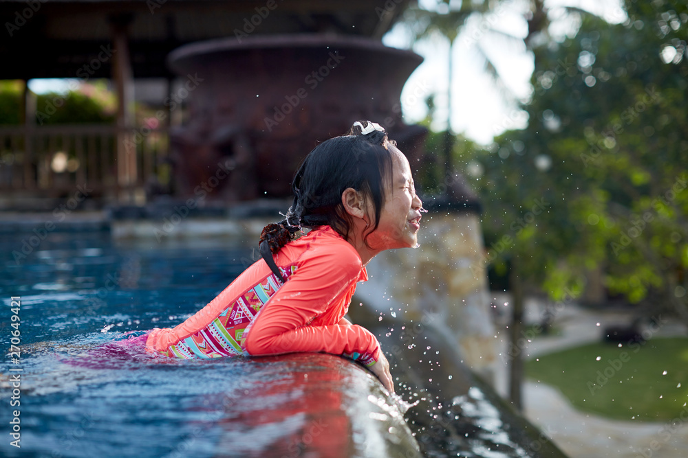 Cute asian little girl playing in the pool Stock Photo | Adobe Stock